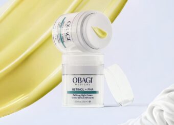 Olay moisturizer jar with cream and a yellow smear background.