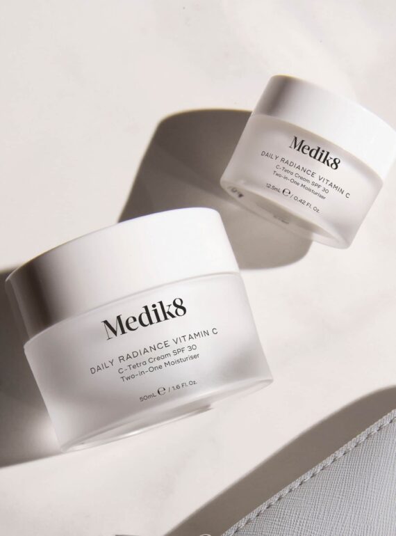 Medik8 skincare jars on a marble surface.