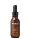 Brown dropper bottle labeled Medliks for skincare.