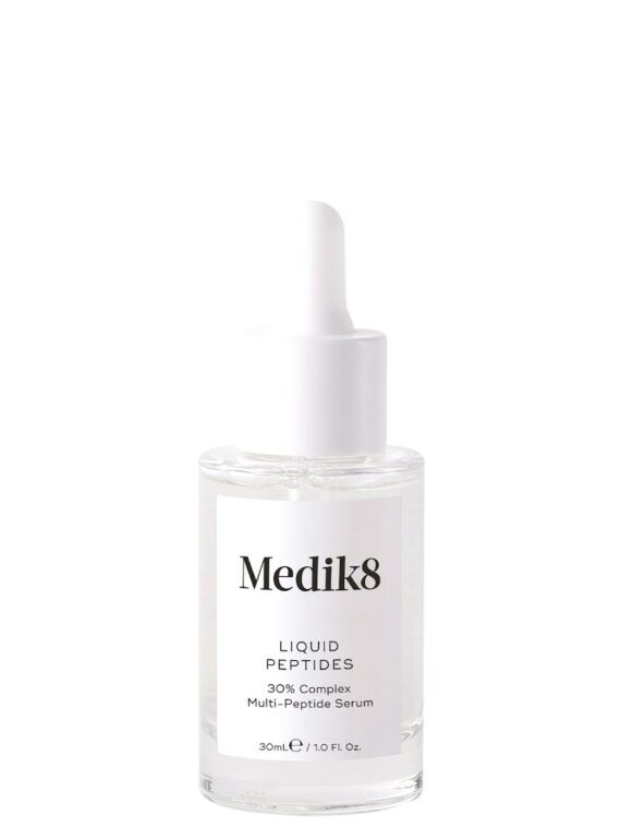 Clear dropper bottle of Medik8 skincare serum on white background.