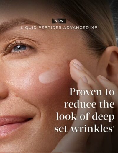 Close-up of a woman applying wrinkle-reducing cream near her eye.