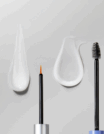 Two makeup brushes with foundation and mascara smears on a grey surface.