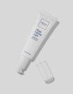 A white tube of skincare product with its cap off on a gray background.