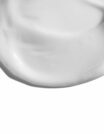 Smooth white cream texture on a white background.