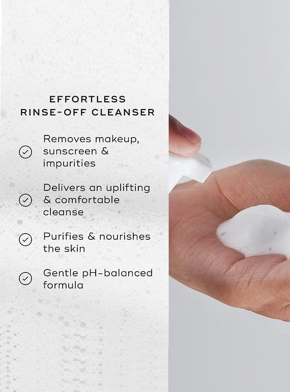 Hand holding a white cleansing pad with rinse-off cleanser benefits listed.