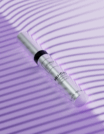 A syringe on a purple striped surface.