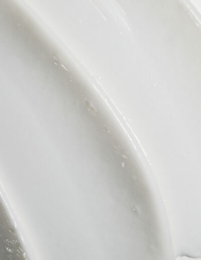 Close-up of smooth white ceramic surface with curved ridges.