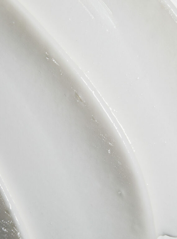 Close-up of smooth white ceramic surface with curved ridges.