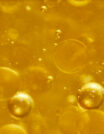 Close-up of golden liquid with bubbles inside.
