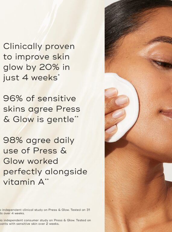 Woman applying skincare product on cheek.
