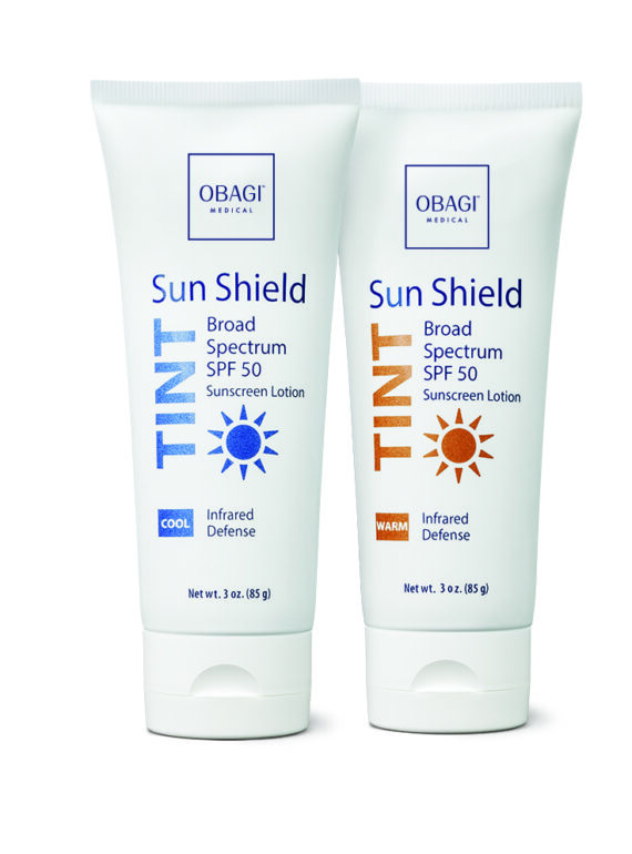 Two tubes of OBAG Sun Shield SPF 50 PA+++ sunscreen in blue and orange packaging.
