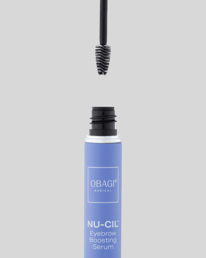 Open mascara tube with wand above it on a light background.